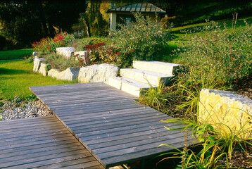 Holzsteg aus Lärchenholz auf zwei Höhen mit Blockstufen aus Granit im Anschluss