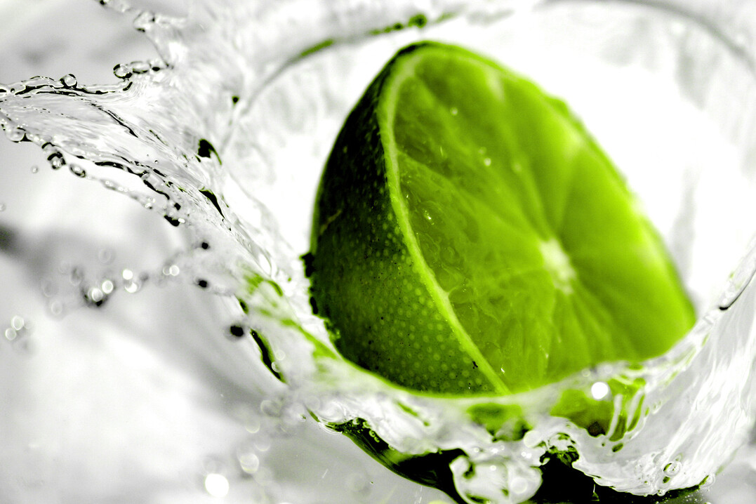 Lime splashing into water. Extremely shallow DoF
