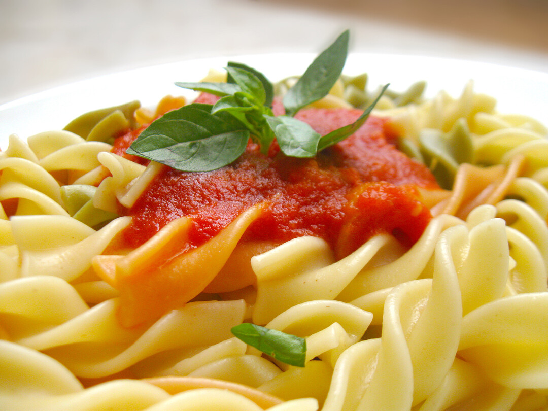 A lovely pasta with a bright red tomato sauce and some fresh basil